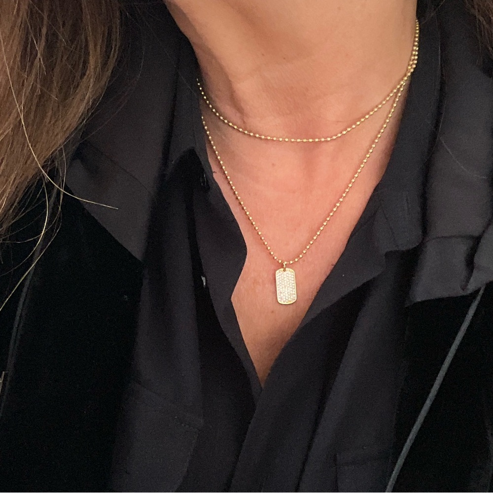 Gold micro pave dog tag on matte gold chain.